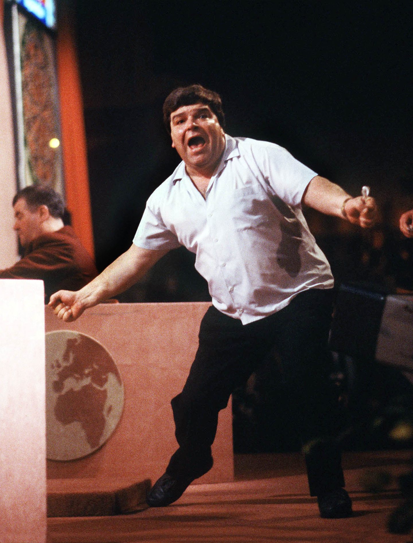 Jocky Wilson celebrates after winning the 1989 title following a 6-4 victory against Bristow