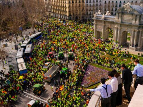 People look down at a protest in Madrid, Spain as hundreds of farmers drove their tractors into the capital as part of ongoing protests against European Union and local farming policies (Manu Fernandez/AP)