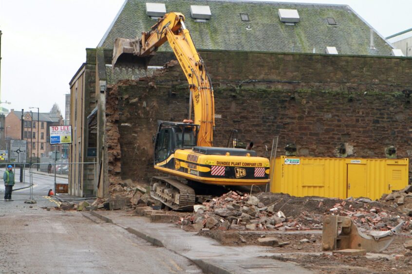 A bulldozer gets to work at the site of the former nightclub in 2014. 