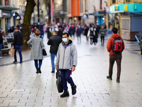 Shoppers walk through the centre of Cardiff, Wales as new Covid-19 rules came into force in 2021 (Ben Birchall/PA)
