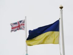 A Ukrainian and Union flag flying (PA)