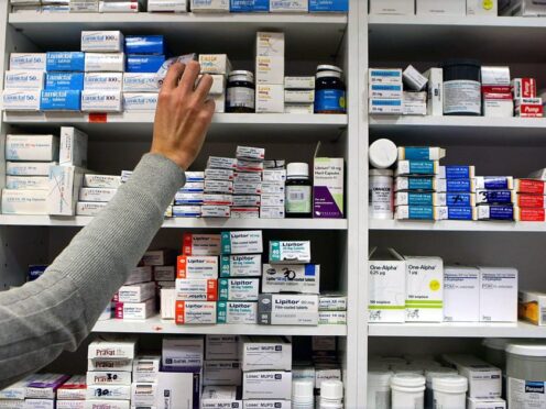 A pharmacist stocking shelves at a chemist (Julien Behal/PA)