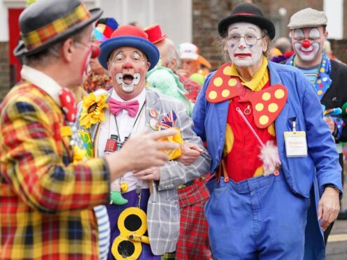 Clowns arrive at the annual Grimaldi Clown Service at All Saints in Hackney, London (Jonathan Brady/PA)