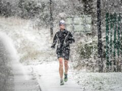 The snow did not deter one hardy runner in North Yorkshire (Danny Lawson/PA)