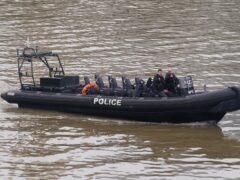 Members of the Metropolitan Police Marine Policing Unit pass near to Chelsea Bridge (Lucy North/PA)
