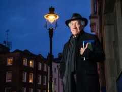 Actor Simon Callow stands under one of four gas lamps along Russell Street in Covent Garden (Matt Crossick/PA)