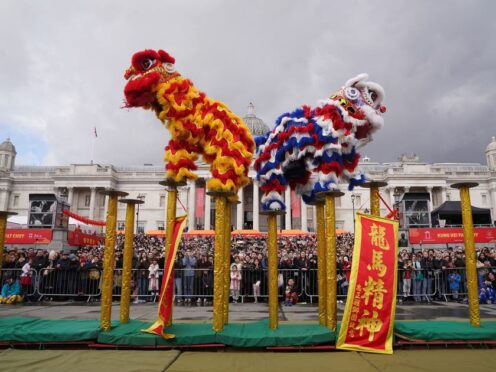 Performers take part in celebrations involving costumes, lion dances and floats in London’s Trafalgar Square (Lucy North/PA)