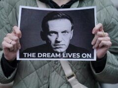 A protester holds a picture of Alexei Navalny at a protest opposite the Russian Embassy in London (Jonathan Brady/PA)