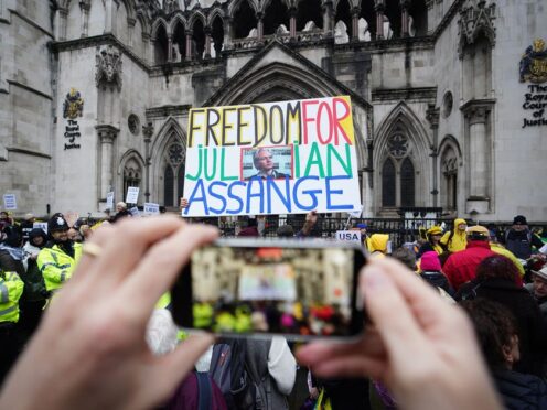 Julian Assange supporters outside the Royal Courts of Justice in London during a hearing in the extradition case of the WikiLeaks founder (James Manning/PA)