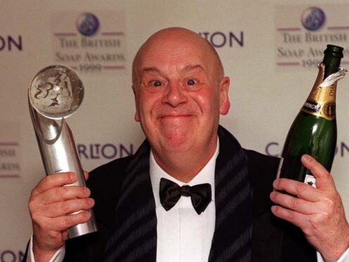 John Savident celebrating Coronation Street winning best soap at the British Soap Awards in 1999 (PA)