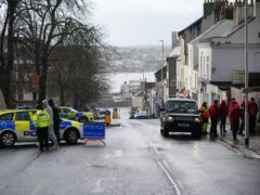 Emergency workers gather before a suspected Second World War explosive device, discovered in a garden in St Michael Avenue in Plymouth, is taken by military convoy to be disposed of at sea (Ben Birchall/PA)