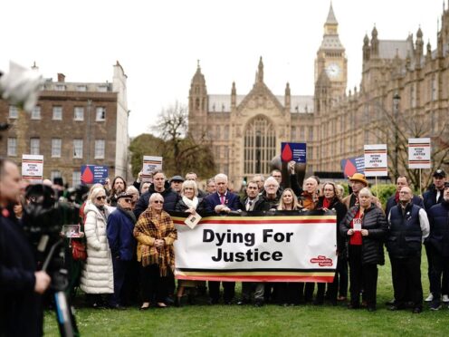Infected blood victims and campaigners protest on College Green in Westminster (PA)