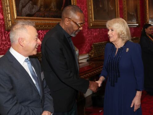 The Queen shakes hands with Sir Lenny Henry during a reception at Buckingham Palace in London with finalists, judges and celebrity readers, to celebrate the final of the BBC’s creative writing competition, 500 Words (Chris Jackson/PA)