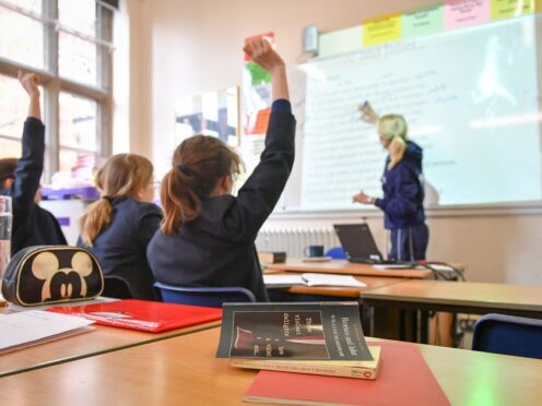 Parents in England who take their children out of class without permission will face higher fines as part of a drive to boost school attendance (Ben Birchall/PA)