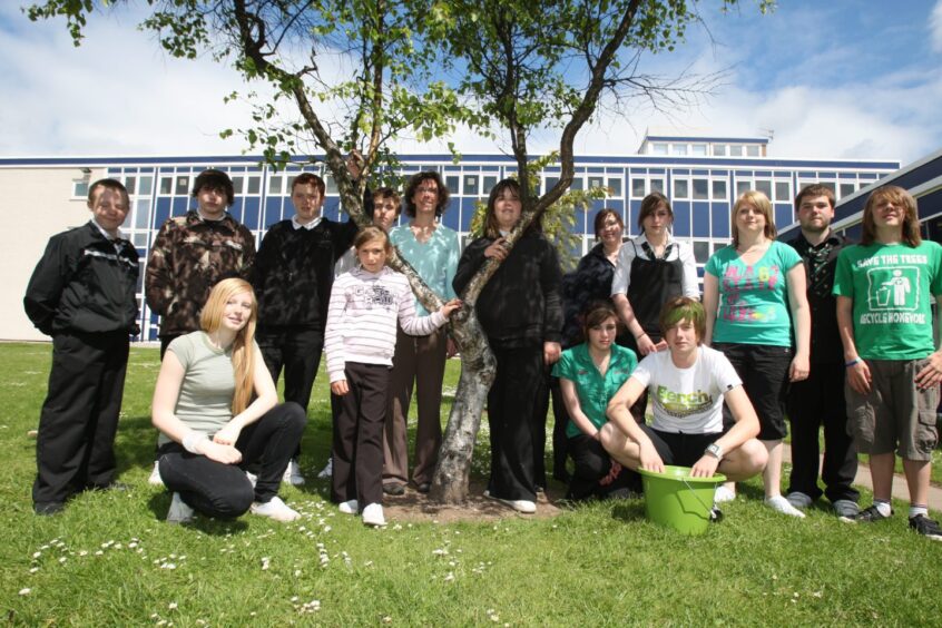 Some of the pupils identifying trees with teacher Ann Sanger.