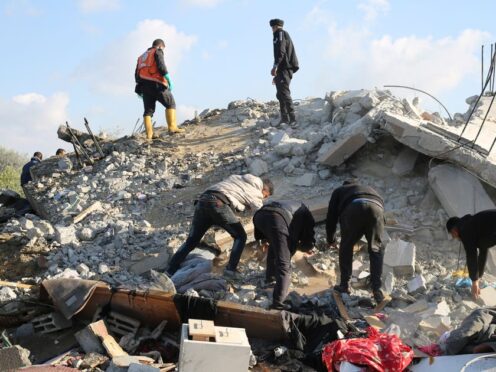 Palestinians search for survivors after an Israeli air strike on a residential building In Rafah (Hatem Ali/AP)