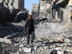 A Palestinian looks at the destruction after an Israeli strike on residential buildings in Rafah, Gaza Strip (Hatem Ali/AP)