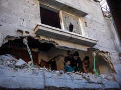 Palestinians check the destruction after an Israeli strike in Rafah, southern Gaza Strip, on Thursday (Fatima Shbair/AP)