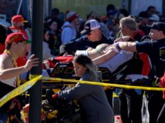 A woman is taken an ambulance (Reed Hoffmann/AP)