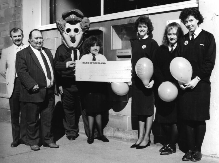 Pupils hand over a Comic Relief cheque from Arbroath Academy. 