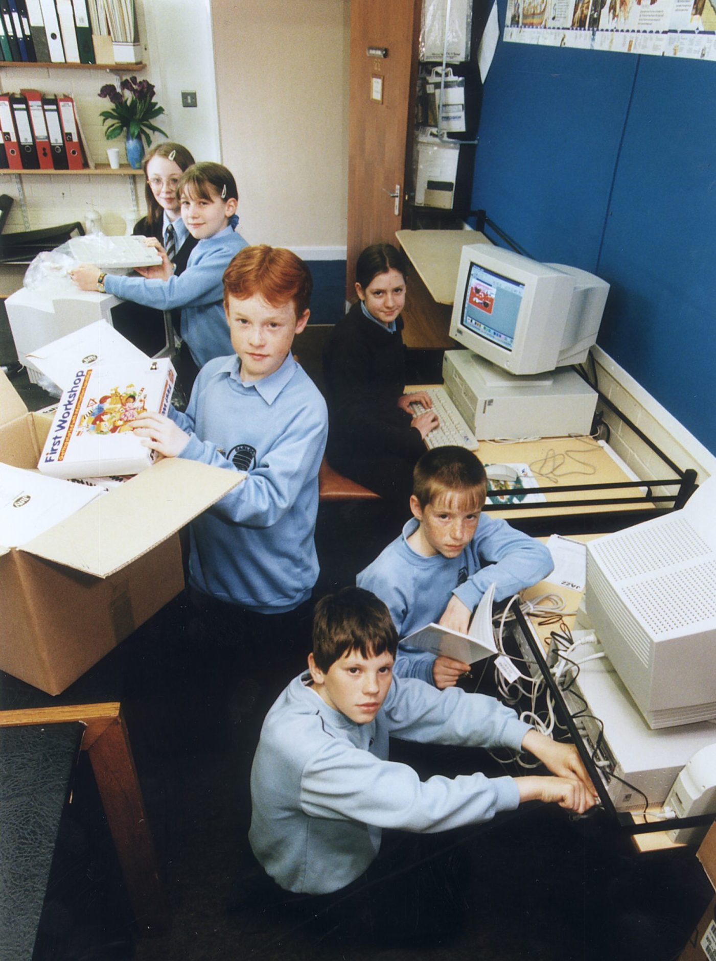 The Carlogie Primary School pupils unpacking the new computer equipment.
