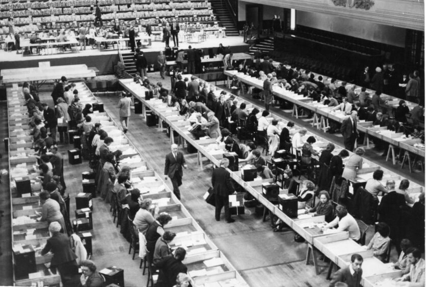 Counters at a row of tables as referendum votes are counted in the Caird Hall in 1979.