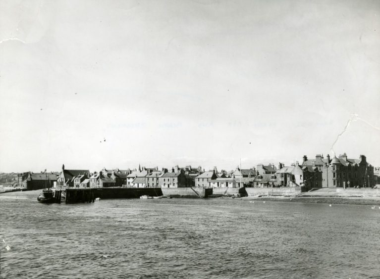 The River Tay flows by Broughty Ferry lifeboat shed and pier in 1957. 