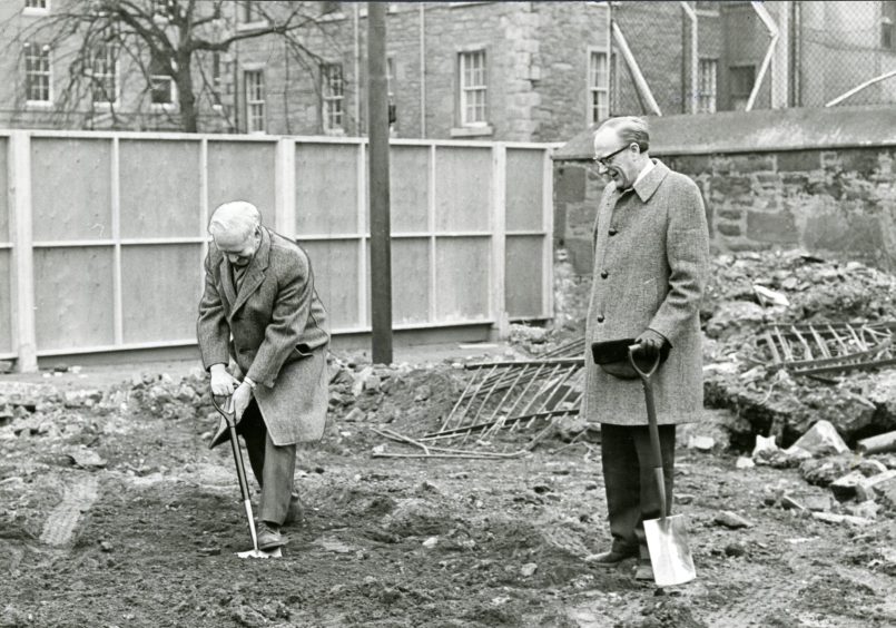 Professor James Drever cutting the first sod, watched by Professor Gavin McDonald. Image; DC Thomson.