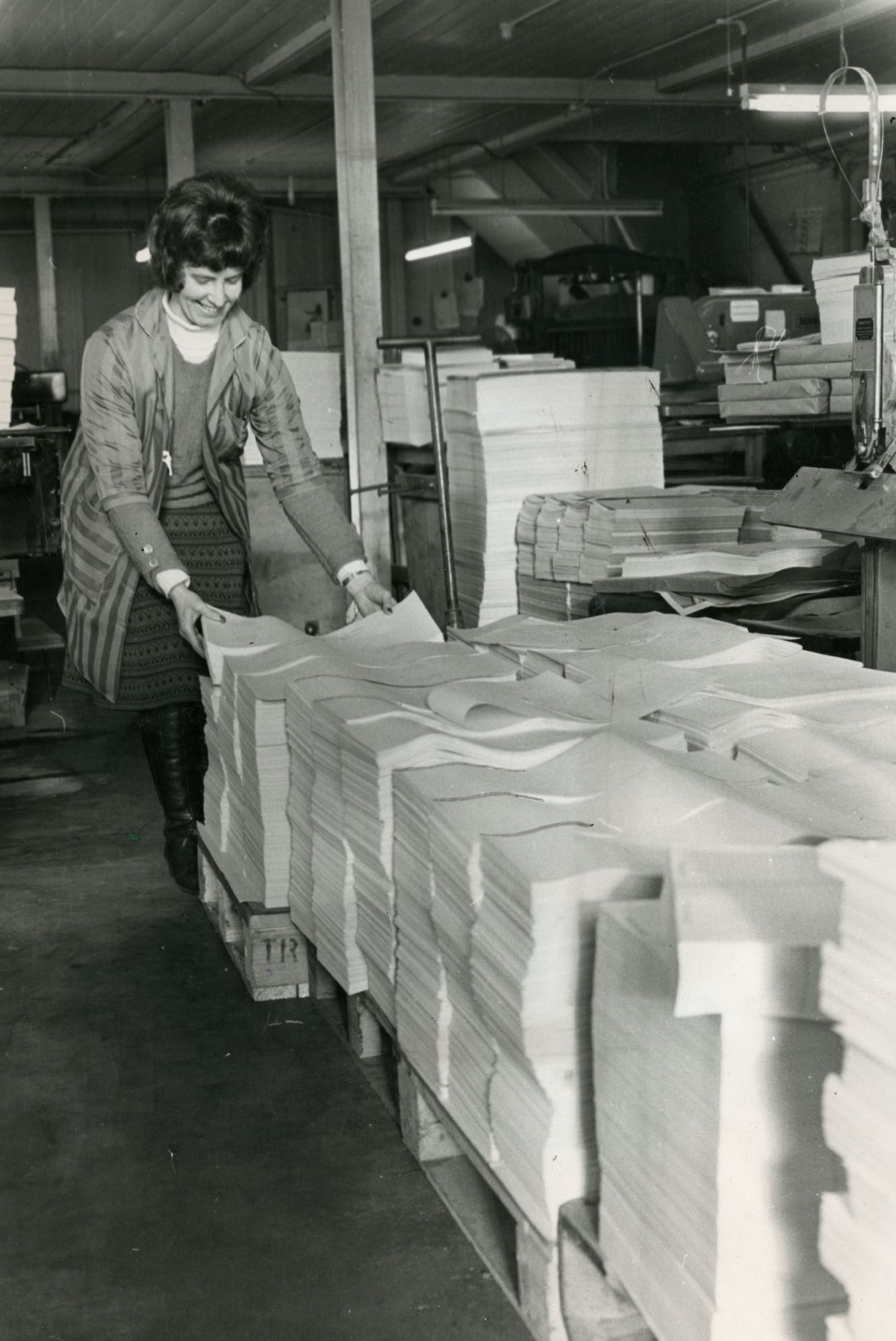 A woman is seen beside sheets of paper at, David Winter &amp; Sons of Dundee, which won the contract to produce the Tayside ballot papers.
