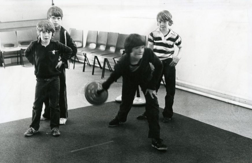 Children try curling at Lochee Leisure Centre. 