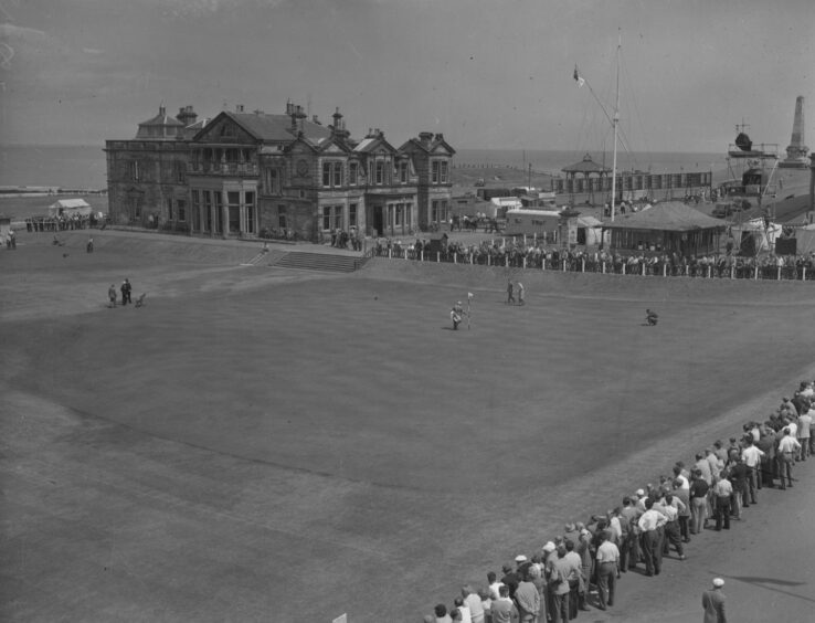 Fans watch the action on one of the holes at The Old Course at St Andrews in 1957.