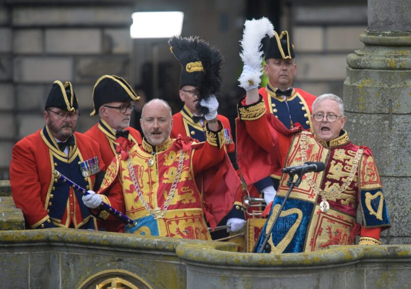 The Lord Lyon leads Three Cheers for the King at the Accession Proclamation Ceremony at Mercat Cross, Edinburgh, on September 11 2022. The Lord Lyon and his staff are wearing tabards created by Eileen.