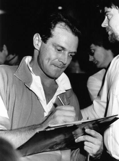 DJ Peter Powell signs autographs for fans at Flicks in Brechin.