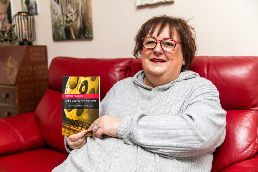 Pamela Mulgrew, holding her book, has charted the cinema's story. 
