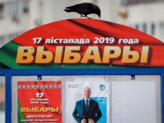 A crow sits on an election poster in Minsk, Belarus, on Nov. 13, 2019. (File/AP)