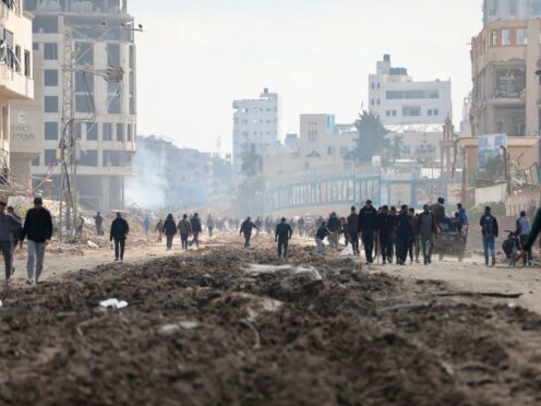 Palestinians walk through the destruction left by the Israeli air and ground offensive on the Gaza Strip in Gaza City on February 10 (AP Photo/Mohammed Hajjar)