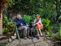 Jon and Jeanette King sitting in the garden with dementia dog Lenny – (Dougie Cunningham/PA Wire).