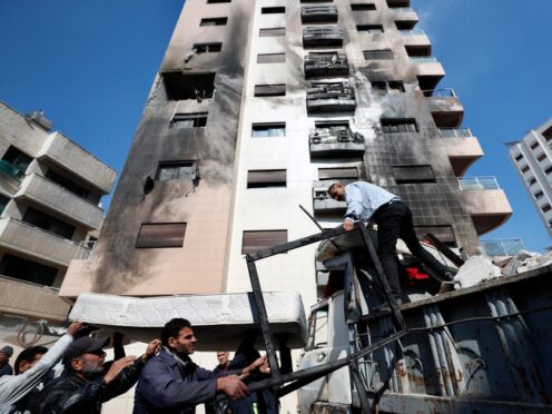 People clean debris after a reported Israeli attack on Syria in Kfar Sousseht, Damascus (Omar Sanadiki/AP)