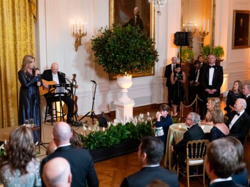 President Joe Biden and first lady Jill Biden listen to country singer Trisha Yearwood perform during a reception for members of the National Governors Association and their spouses in the East Room of the White House (Stephanie Scarbrough/AP)
