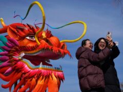 Women take a selfie with a giant dragon lantern near the frozen Houhai Lake in Beijing (Andy Wong/AP)