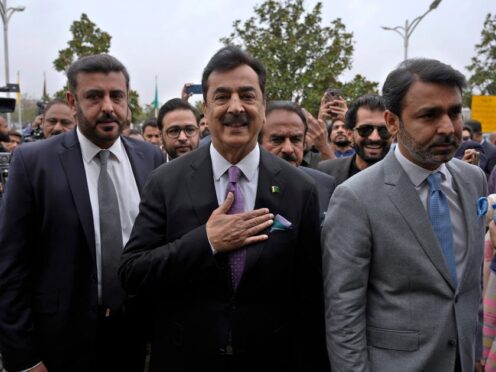 Newly elected lawmaker Yusuf Raza Gilani, centre, arrives at the opening session of Parliament (Anjum Naveed/AP)