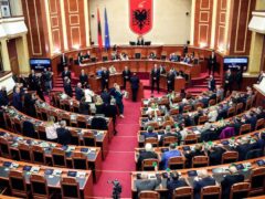 Members of the Democratic Party (left) look on as lawmakers of the ruling Socialist party vote in the Albanian Parliament (Armando Babani/AP/PA)