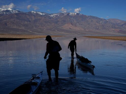 People pull kayaks into the water at Badwater Basin in Death Valley National Park (John Locher/AP)