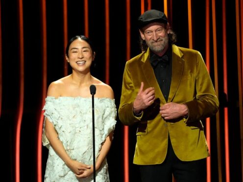 Greta Lee, left, and Troy Kotsur present the award for outstanding performance by a male actor in a television movie or limited series during the 30th annual Screen Actors Guild Awards (AP Photo/Chris Pizzello)