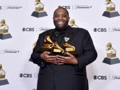 Killer Mike poses in the press room with the awards for best rap performance and best rap song for Scientists & Engineers, and best rap album for Michael during the 66th annual Grammy Awards in Los Angeles (Richard Shotwell/Invision/AP)