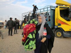 A Palestinian woman fleeing the Israeli offensive arrives in Rafah (AP Photo/Hatem Ali)