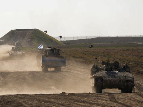 Israeli troops move near the Gaza Strip border in southern Israel (Ohad Zwigenberg/AP)