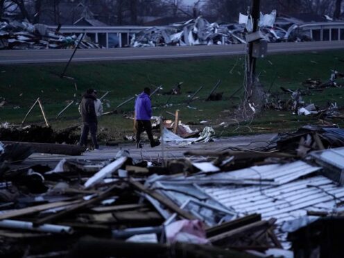 People walk through debris from severe storms in Lakeview, Ohio (Joshua A Bickel/AP)