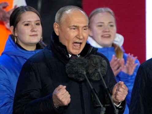 Russian President Vladimir Putin speaks at a concert marking his victory in the presidential election and the 10-year anniversary of Crimea’s annexation by Russia on Red Square in Moscow, Russia, on Monday (Alexander Zemlianichenko/AP)