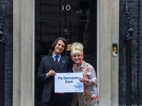 Dame Barbara Windsor and her husband Scott Mitchell deliver an Alzheimer’s Society open letter to 10 Downing Street in Westminster before she died (PA)